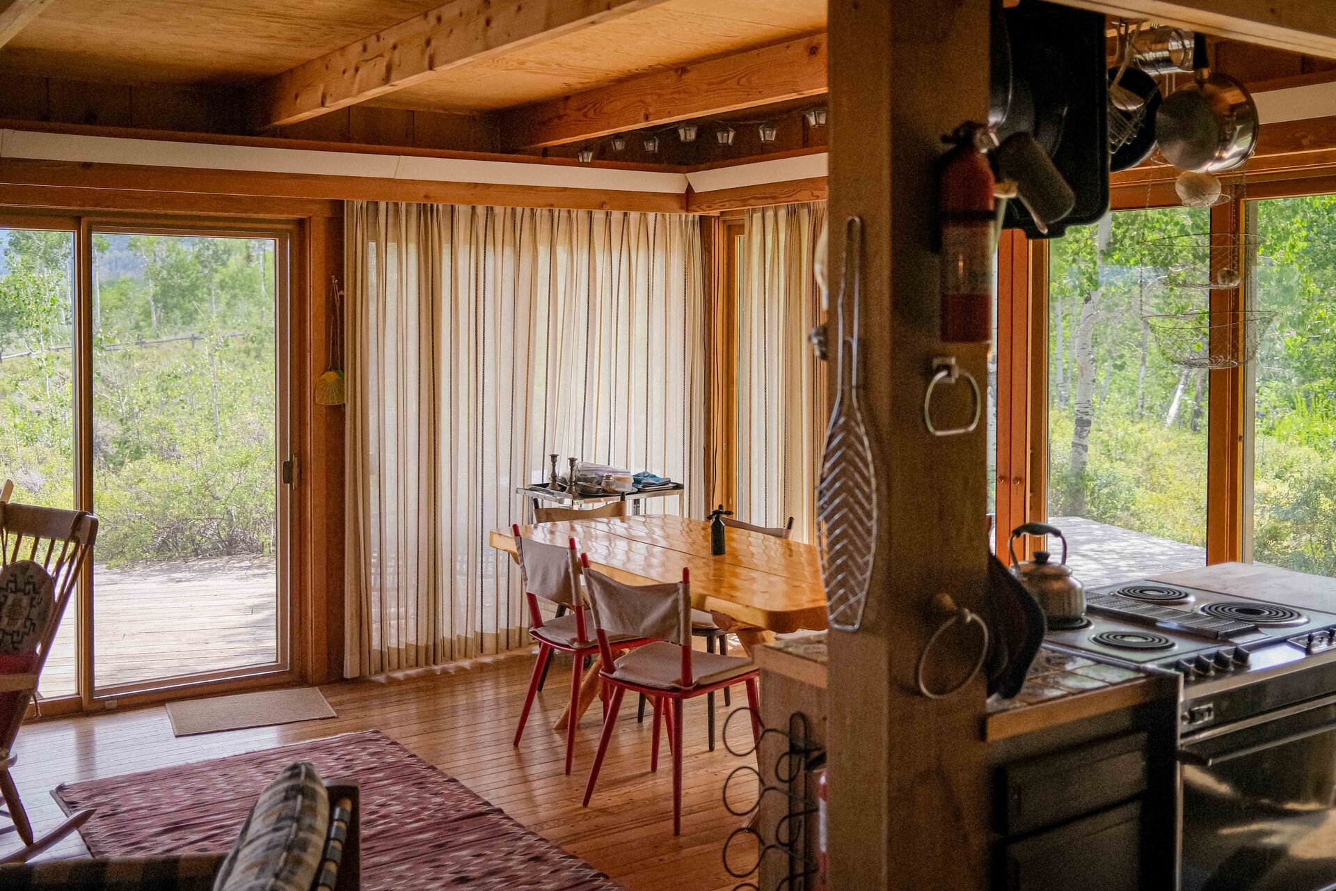 Kitchen and dining area with red chairs and aspen views